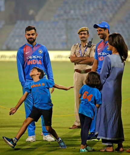 Before everyone goes over the top with comparisons, here is the reason why we are saying this. Aarush was seen copying his father’s bowling action in front of Indian captain Virat Kohli while his parents looked on. (Photo: AP)
