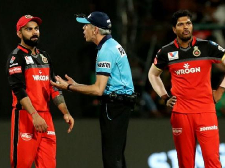 umpire nigel llong starts controversy with door kick in bengaluru after spat with virat kohli IPL 2019: नो बॉल विवाद के बाद नाइजेल लोंग के 'दरवाज़े पर लात' मारने से BCCI नाराज़, जुर्माने के बाद हो सकती है कार्रवाई