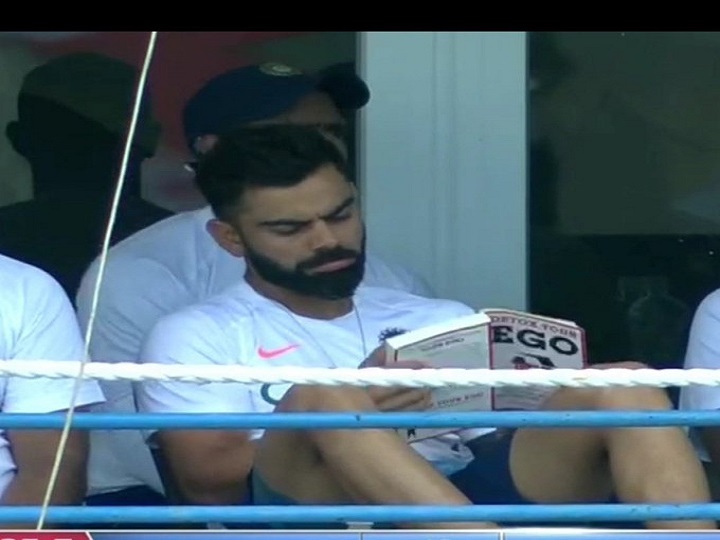 india vs west indies virat kohli reading book titled detox your ego sends twitter into frenzy IND vs WI: ड्रेसिंग रूम में विराट कोहली को पढ़ते देखा गया 'डिटॉक्स यॉर ईगो' किताब, ट्विटर पर फैंस ने किए ये कमेंट